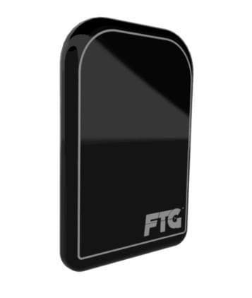 Product render of the DC-Air™ sensor: a black, rounded-corner rectangular intraoral sensor body with the FTG logo on its face, shown at an angle against a white background.