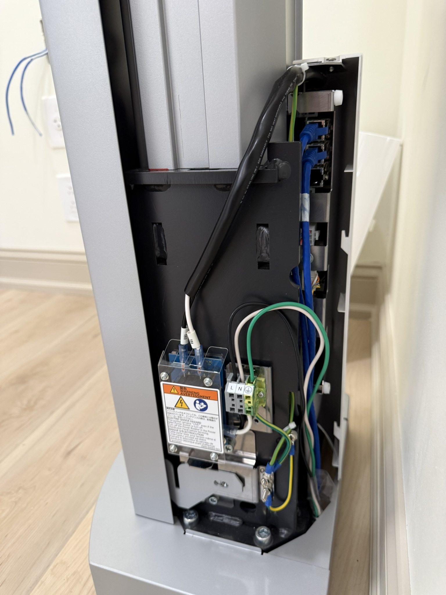 By running power and ethernet up through discrete holes behind the column, we created a cordless aesthetic for this client.